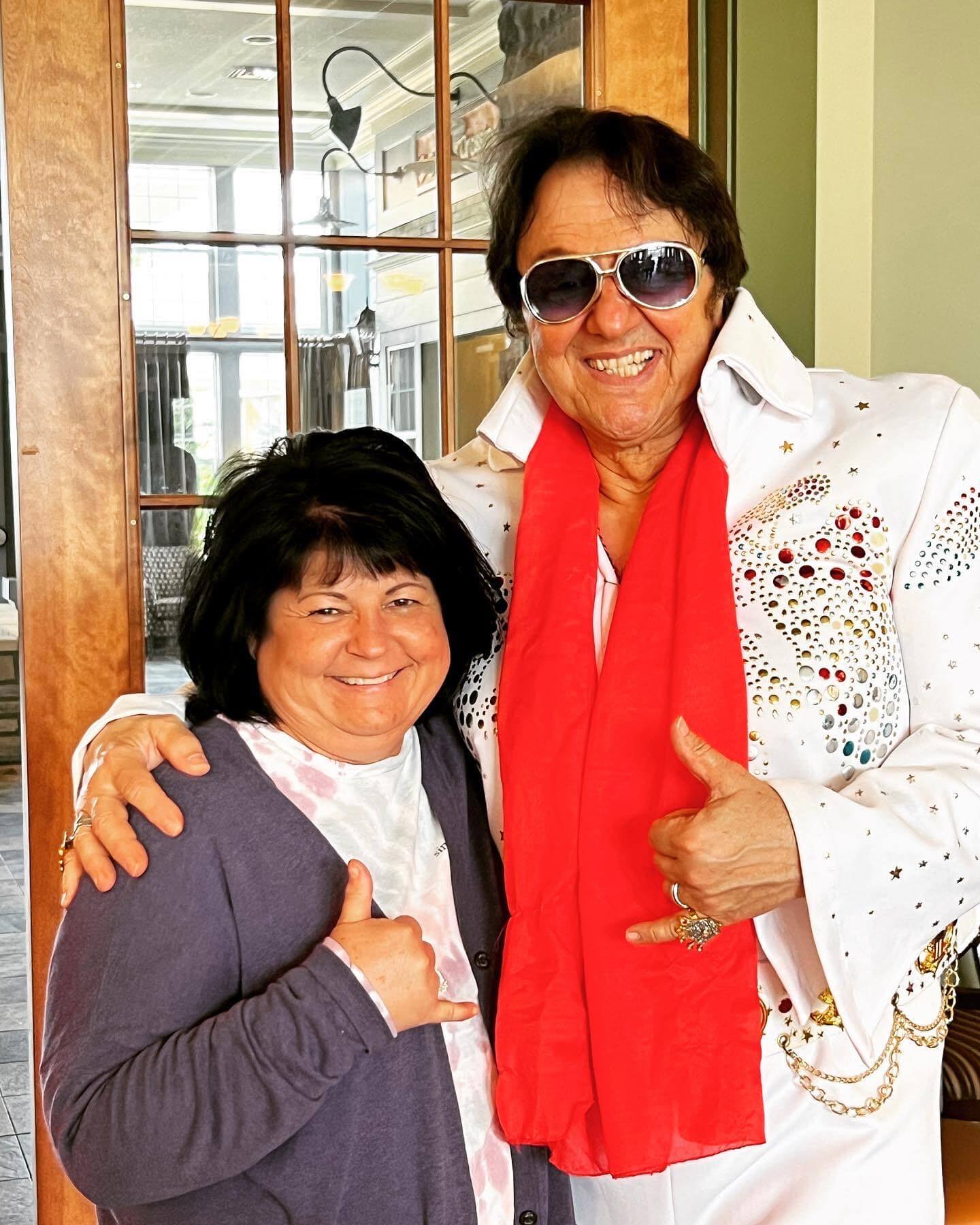 Paul Floriano doing an Elvis impersonation, standing next to a satisfied customer